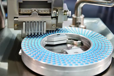 Pills being produced in a manufacturing facility.