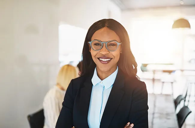 Confident worker woman with glasses looking at camera