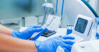 Gloved worker working with medical devices