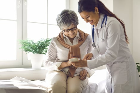 Health professional assisting a patient with a mobile device