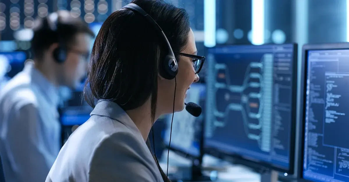 Woman wearing headset at a technology enabled tech call center